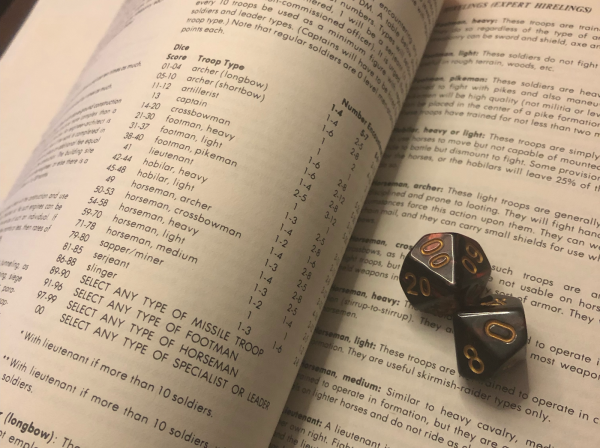 Up-close photo of the DMG's random mercenaries table in the Expert Hirelings section. And some dice.