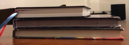 The OSE ref's book, 3rd edition DMG, and AD&D DMG stacked up and viewed from the bottom.