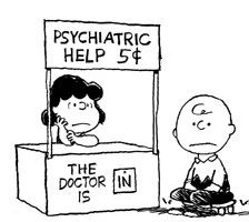 Charlie Brown sitting at Lucy's psychiatric help booth.