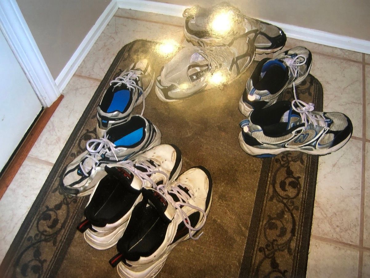 Four pairs of sneakers by my childhood front door.